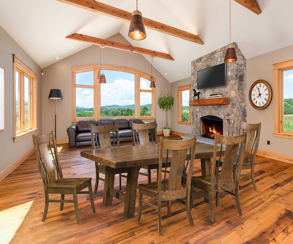 Amish furniture for Appalachian homes in a rustic dining room with beams and stone fireplace.