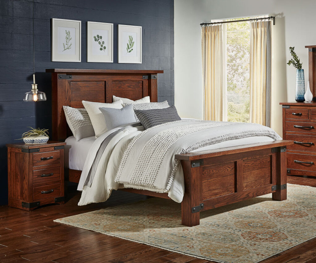 Tudor style Amish furniture bedroom with exposed metal joinery and paneled bed.
