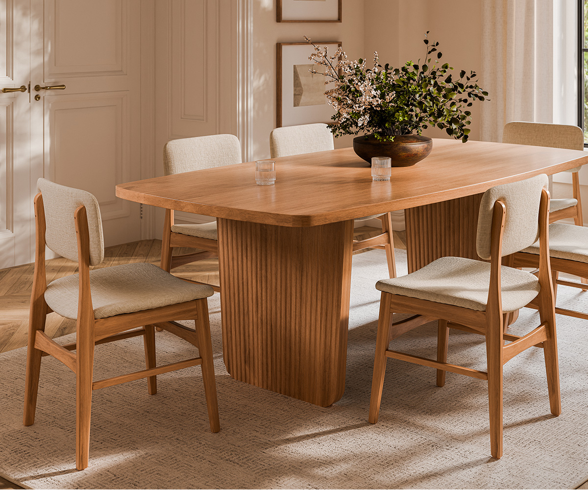 Solid wood dining table set in bright modern dining room.