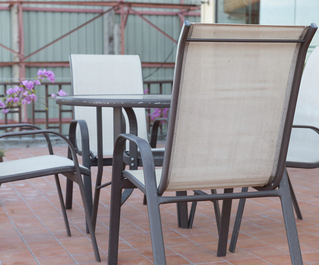 Metal patio table and chairs, store metal outdoor furniture for winter to prevent rust.