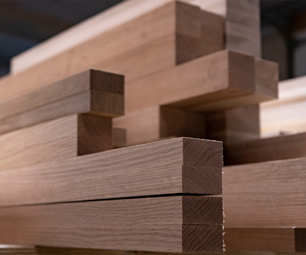 Stacked hardwood beams ready for Amish furniture building.